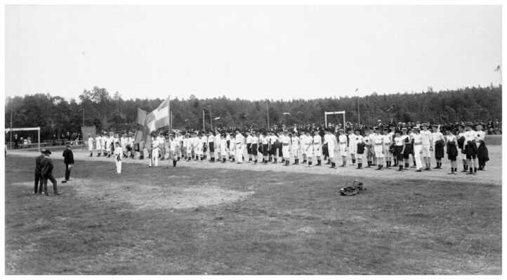 Ett hundratal människor uppklädda i idrottskläder på en idrottsplats.