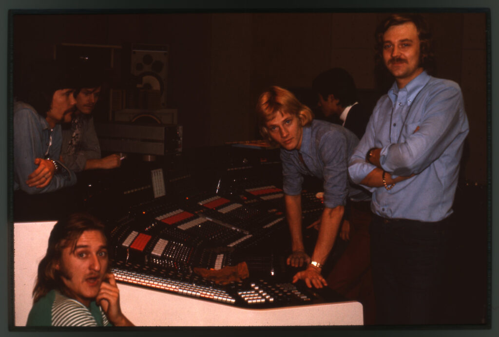 Några män runt ett kontrollbord.